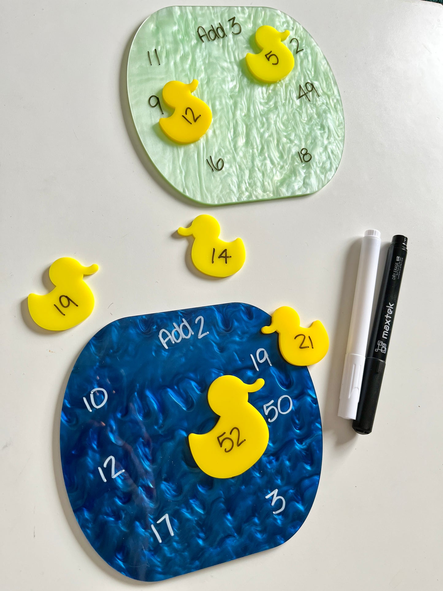 Colorful dry erase fish around a marble dry erase pond on a white background