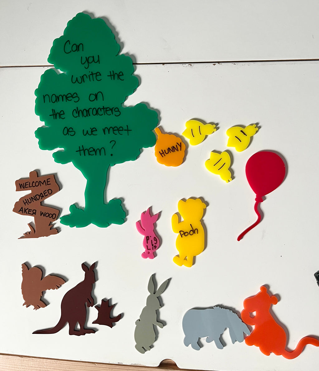 Little Dry Erasables - Winnie & Friends Book Companion Bundle featuring colorful wooden character shapes including Pooh, Piglet, Bees, and Roo alongside a green tree with handwritten prompt, handcrafted homeschool education resources.