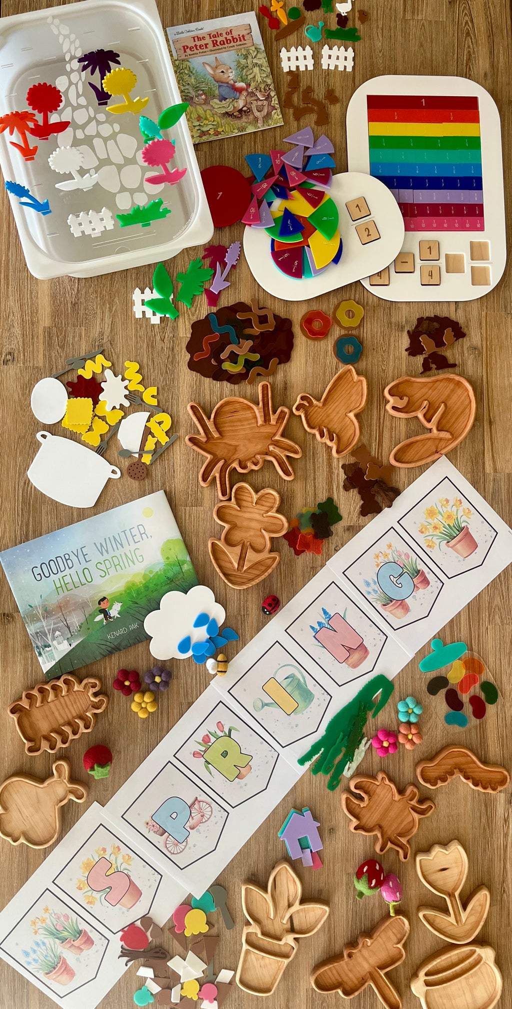 Handcrafted Bug Trays displayed with colorful wooden shapes of insects and plants, sensory fillers, educational puzzles, and spring-themed homeschool resources on a wood surface.