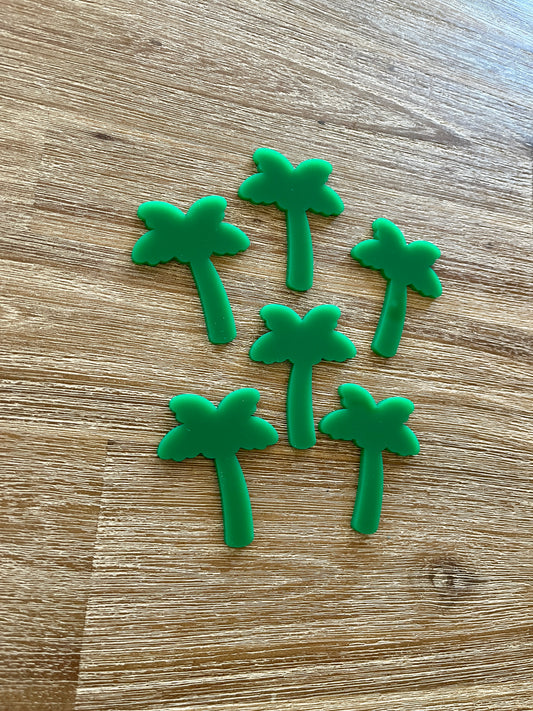 Six small green palm tree shapes made of durable material arranged on a wooden surface, Little Dry Erasables - Palm Trees, handcrafted, homeschool, education resources.