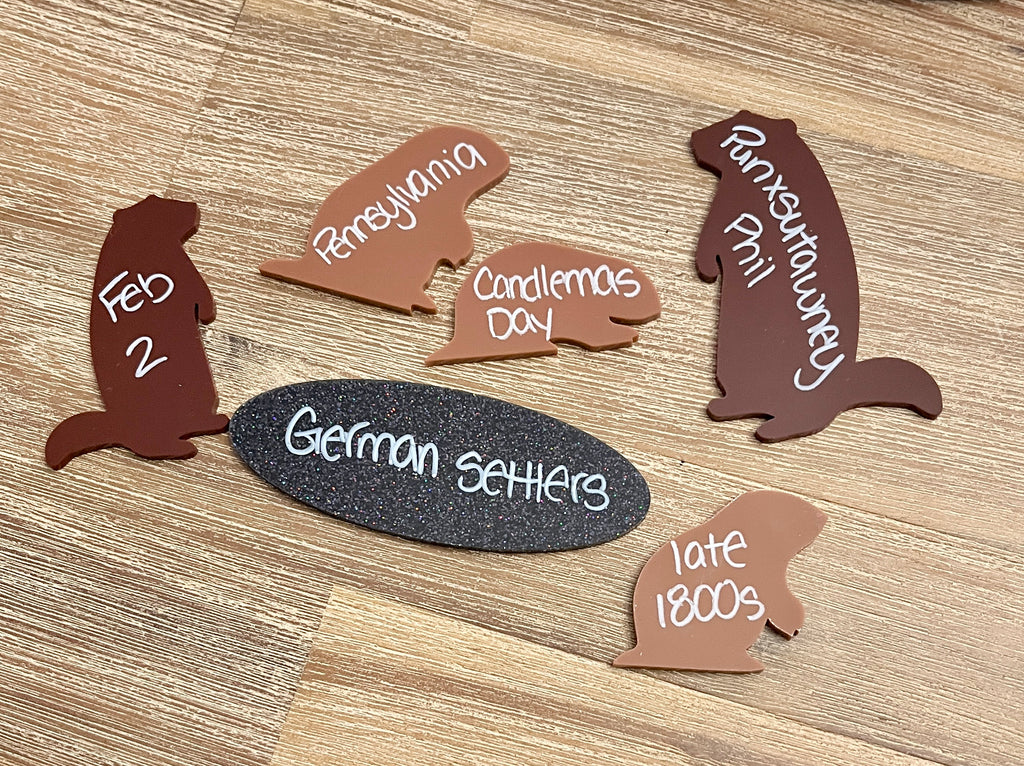 Little Dry Erasables - Groundhog Day featuring wooden groundhog-shaped pieces and an oval blackboard with handwritten historical notes, handcrafted homeschool educational resources.