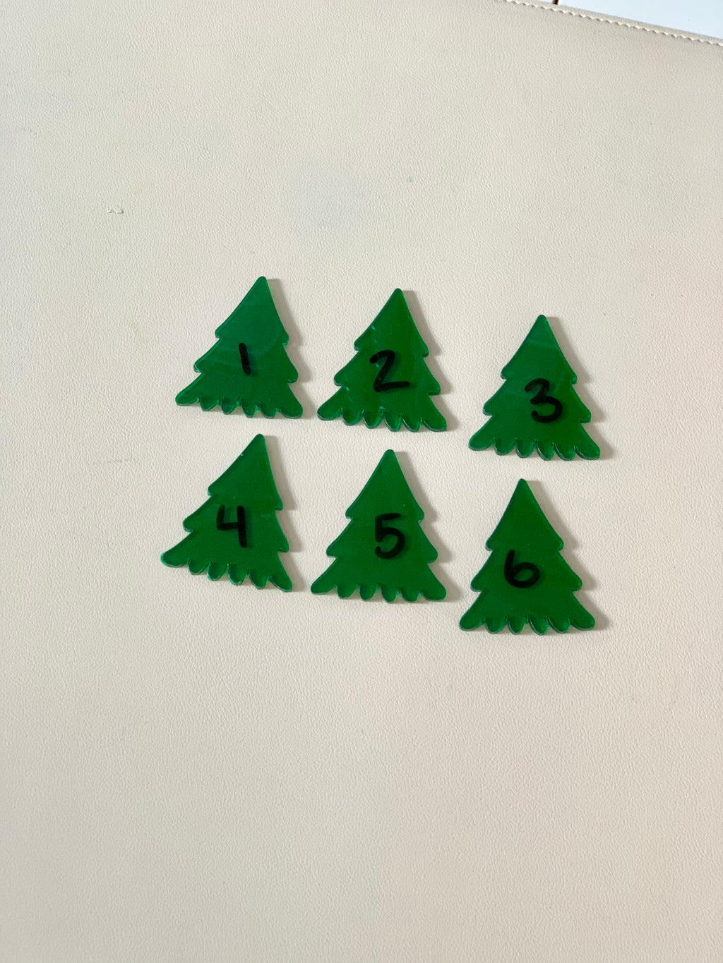 Set of six green pine tree dry erase pieces numbered 1 to 6 on white background