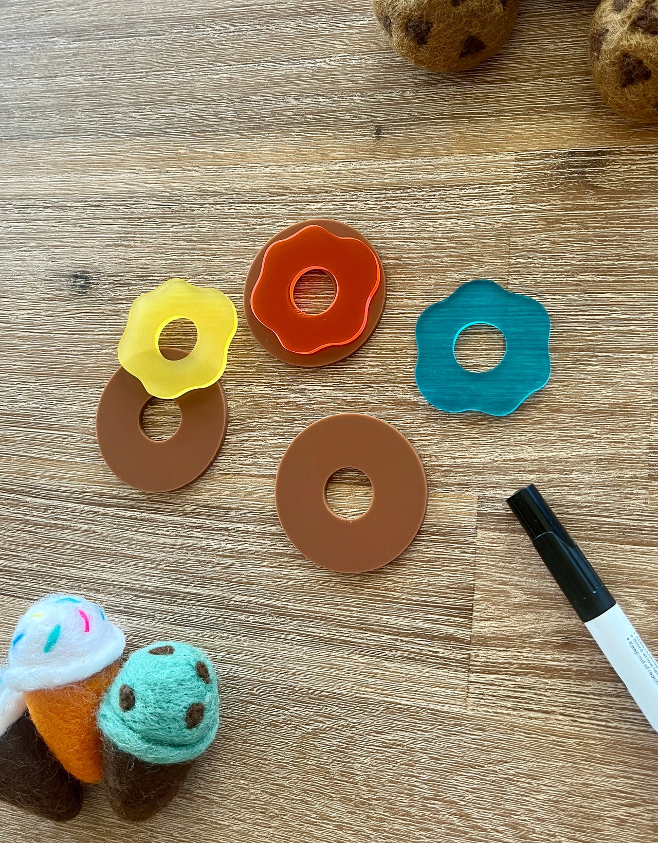 Little Dry Erasables - Donuts with Icing featuring handcrafted wooden donut bases paired with colorful translucent icing pieces, accompanied by felt ice cream cones and a black marker, handcrafted homeschool education resources.