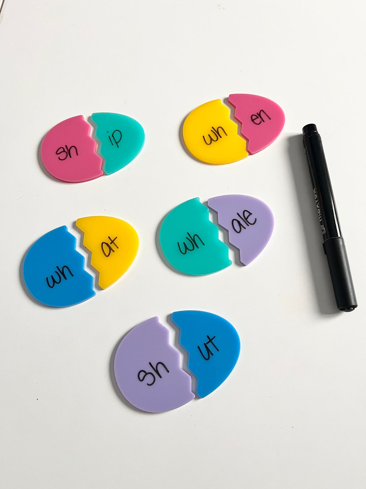 Little Dry Erasables - Pastel Broken Eggs Smaller Size - Set of 5 Eggs featuring colorful pastel egg-shaped pieces paired to form word parts, with a black dry-erase marker, handcrafted homeschool education resources.