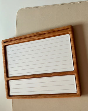 Smaller wooden multipurpose sensory tray with two lined white dry erase inserts and groove for marker on beige surface
