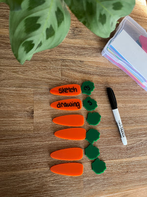 Little Dry Erasables - Small Carrots & Tops - Set of 6 / 12 Pcs Total featuring bright orange carrot pieces paired with green leafy tops, a black dry erase marker on a wood surface, handcrafted homeschool education resources.