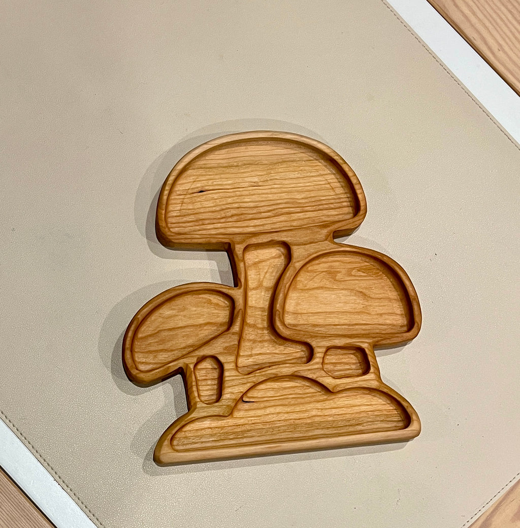 Wooden serving tray carved in the shape of three connected mushrooms with smooth natural finish