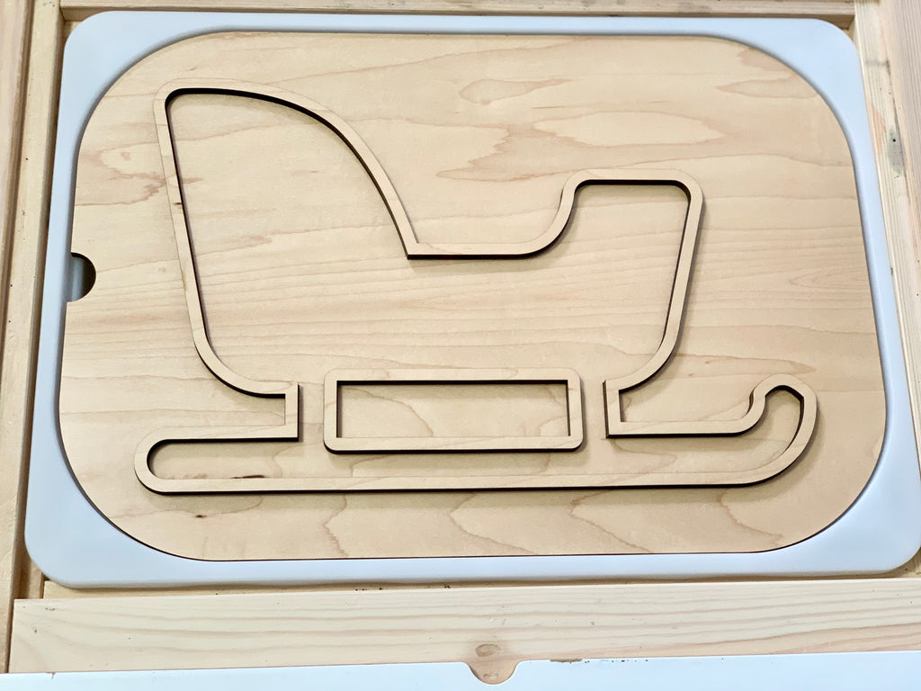 Smooth light maple plywood insert shaped like a sleigh with curved runners and a raised backrest outline