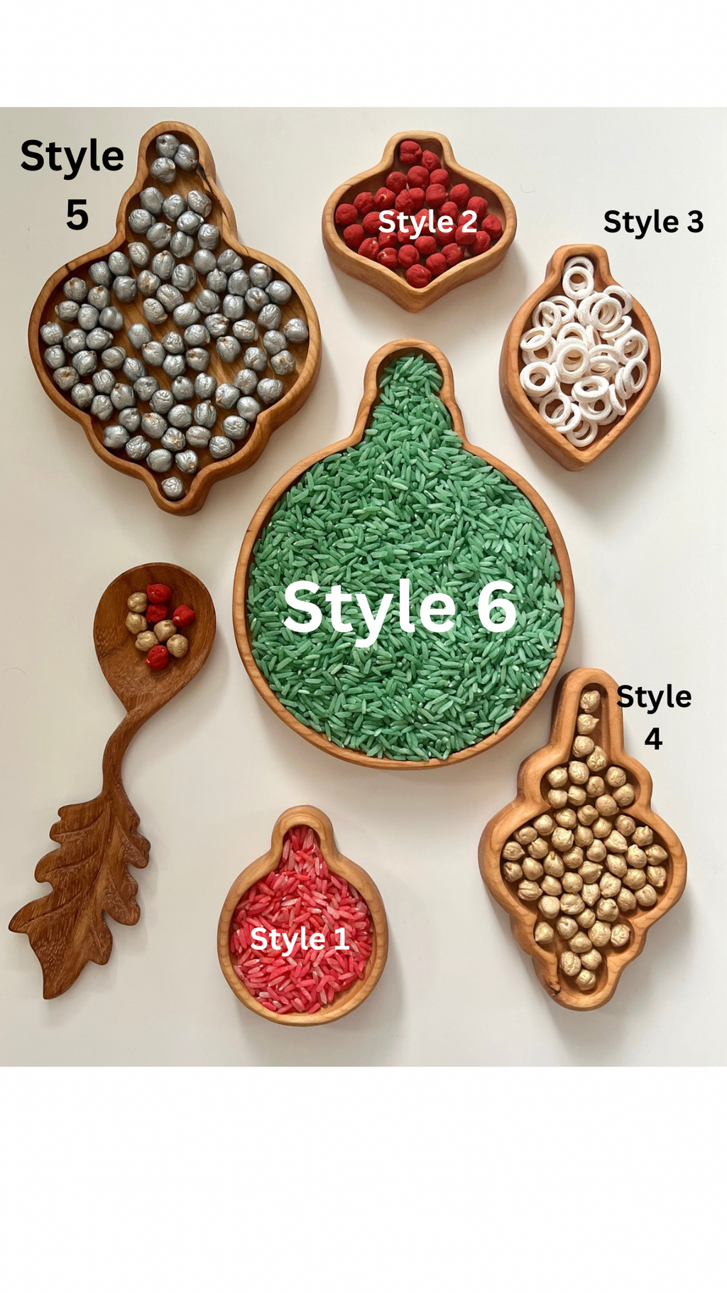 Set of six wooden trays in various ornament shapes filled with colorful rice, beads, and wooden balls on white background