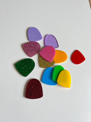 A collection of colorful plastic gumdrop-shaped pieces in purple, pink, orange, red, green, blue, and yellow, styled as Little Dry Erasables — Set of 12 Gumdrops, handcrafted homeschool educational resources.