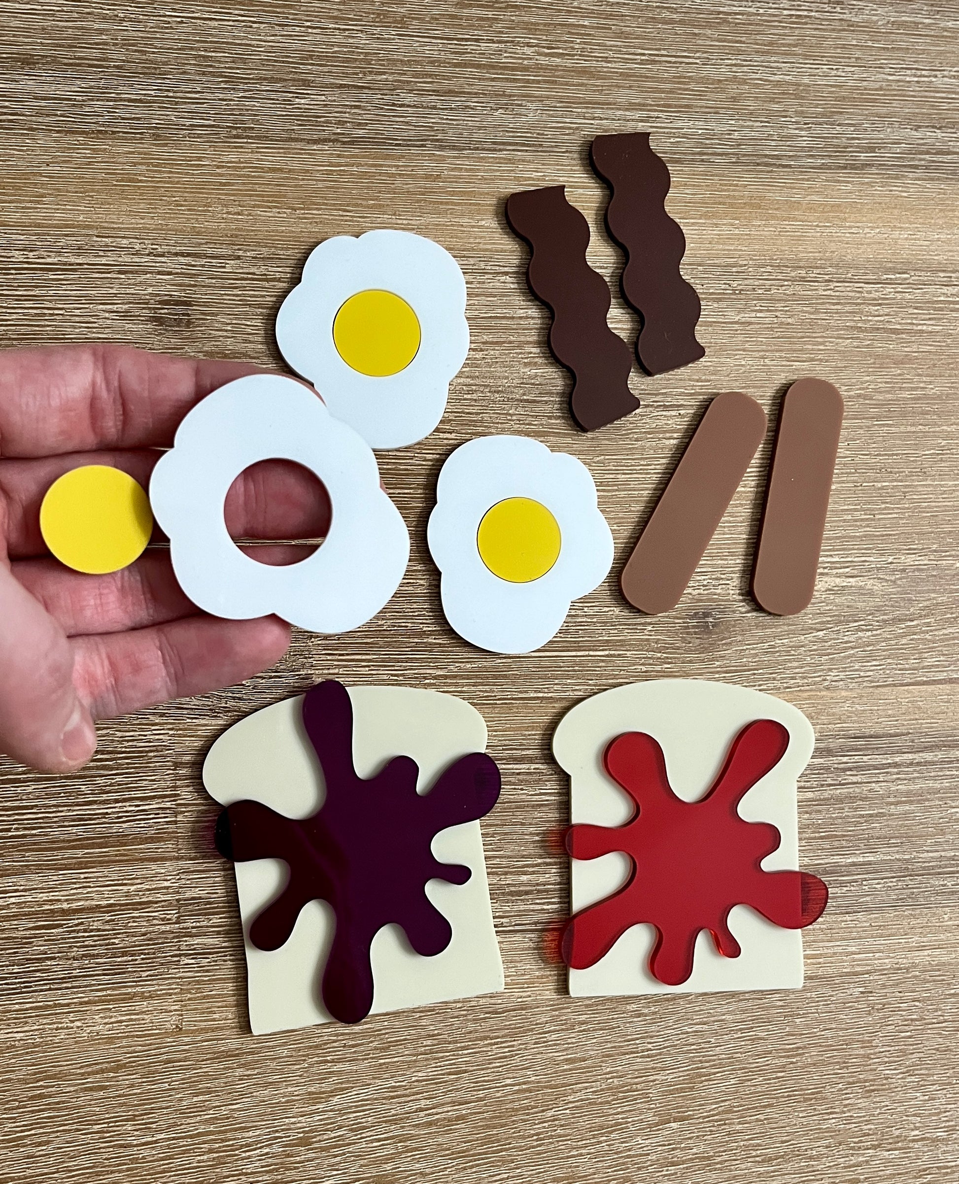 Little Dry Erasables - Breakfast Toast with Jam, Bacon, Sausage and Eggs showing handcrafted wooden play pieces of eggs, bacon strips, sausages, and toast with jam for engaging homeschool education resources.