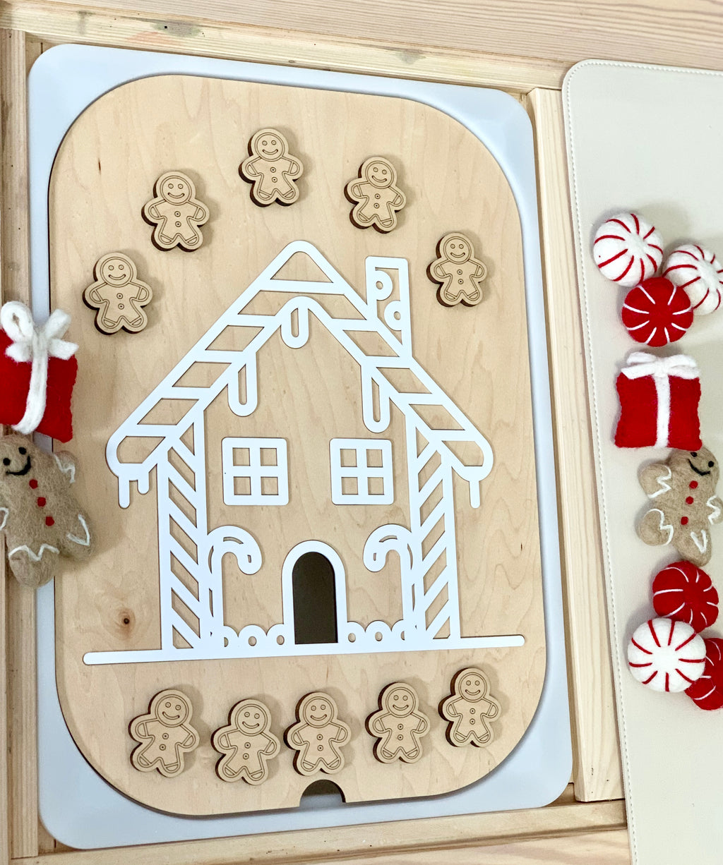 Maple plywood gingerbread house acrylic insert for Flisat bin with ten small wooden gingerbread people on wooden surface