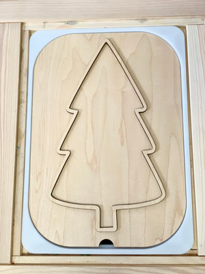 Unfinished light wood puzzle board with a large Christmas tree shape cutout and smooth rounded edges