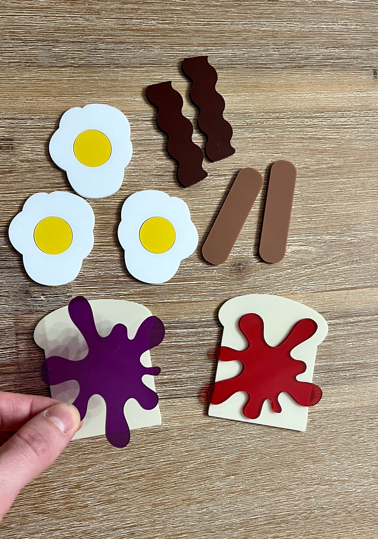 Little Dry Erasables - Breakfast Toast with Jam, Bacon, Sausage and Eggs showing handcrafted wooden play pieces of fried eggs, bacon strips, sausages, toast with colorful jam, homeschool educational resources.