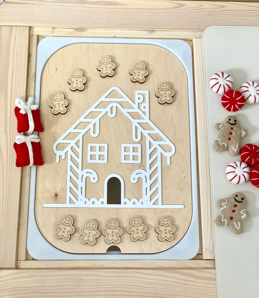 Maple plywood gingerbread house Flisat insert with 10 wooden gingerbread figures on light wood surface