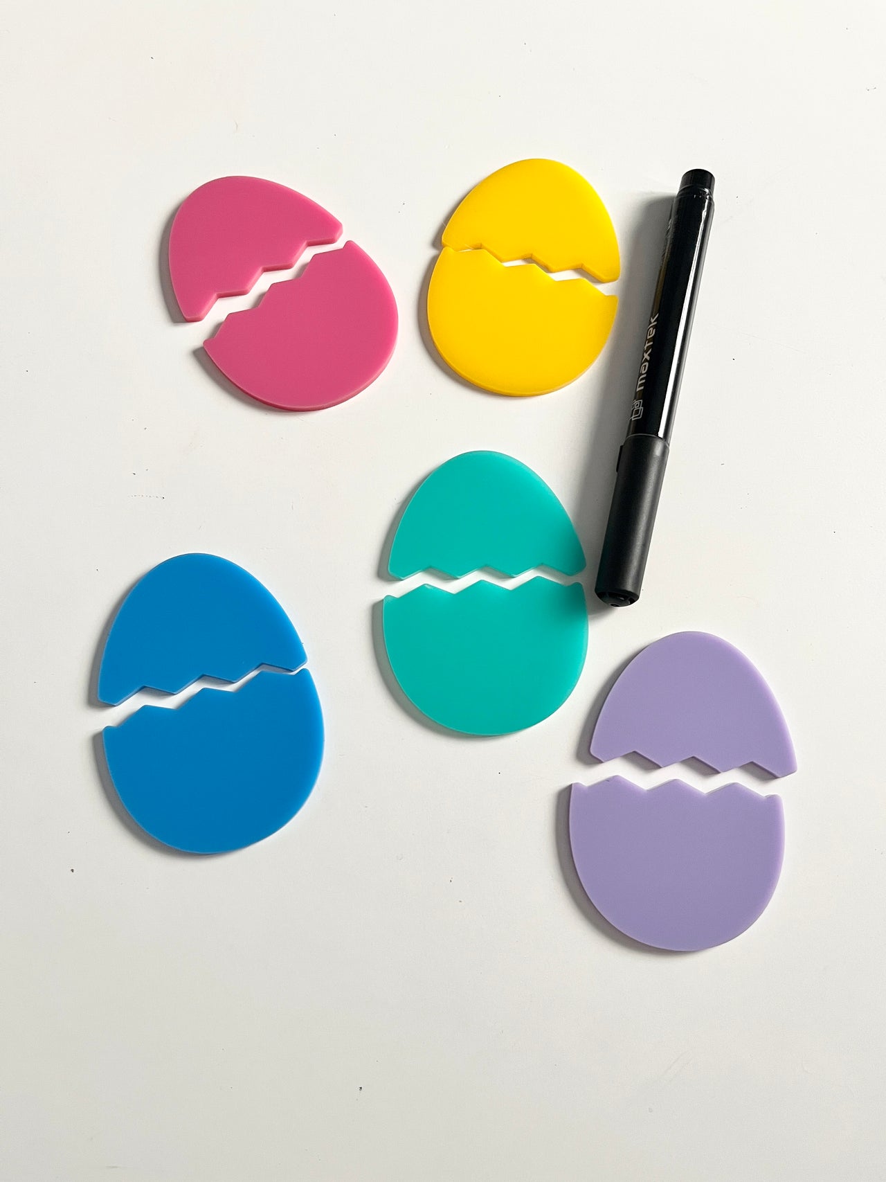 Little Dry Erasables - Pastel Broken Eggs Smaller Size - Set of 5 Eggs displaying colorful pastel egg-shaped cutouts split in half with a black dry-erase marker, handcrafted homeschool education resources.
