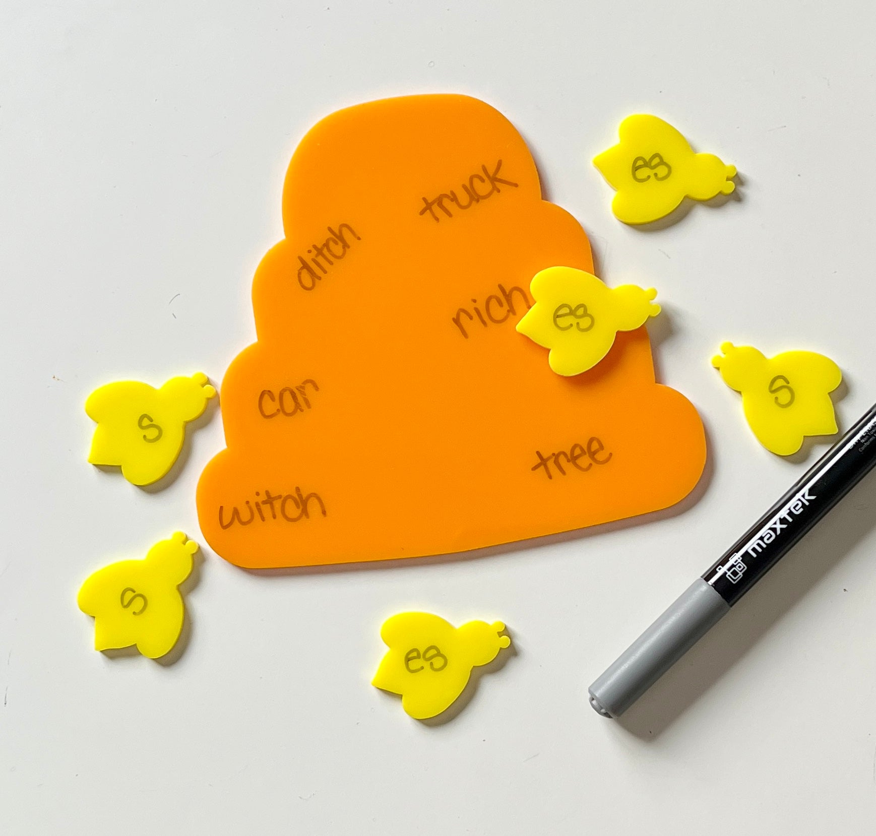 Yellow and orange bee and hive dry erase educational tools on a white background