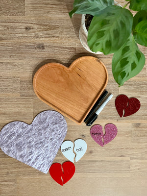 Large Heart Plate / Sensory Tray made of natural wood with a marbled surface insert, surrounded by colorful broken heart word puzzle pieces and markers, handcrafted homeschool education resources.