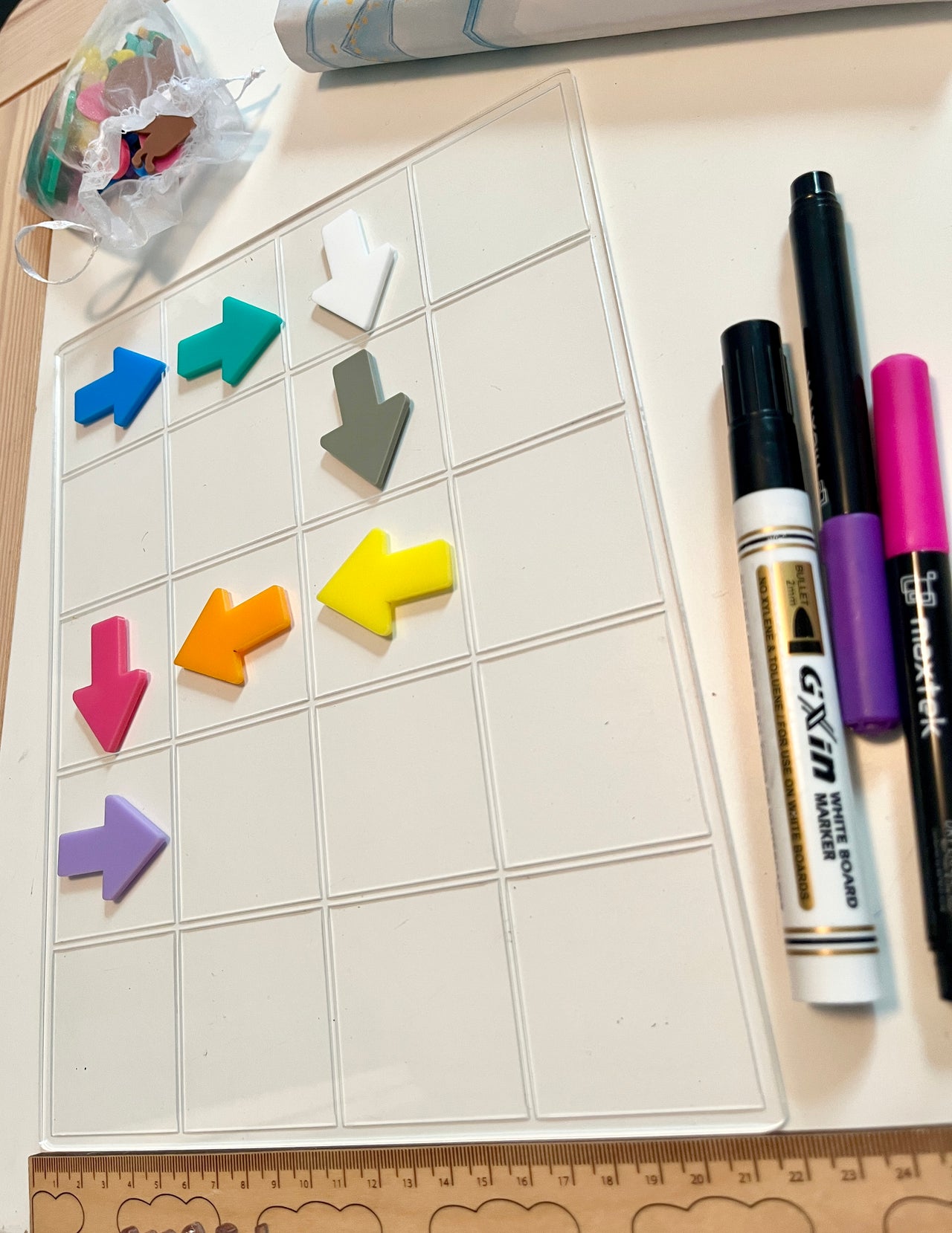 Colorful arrow-shaped dry erase shapes on a 20 frame white board