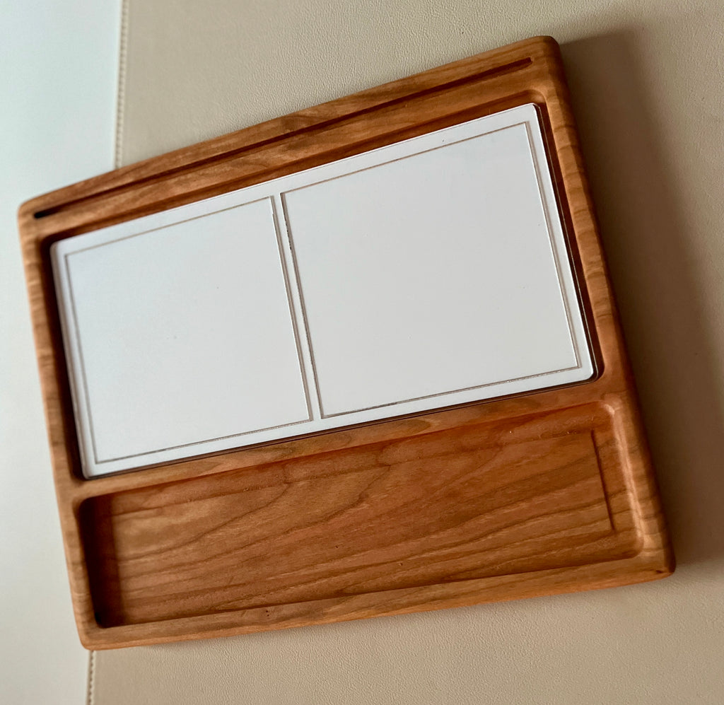 Smaller wooden multipurpose sensory tray with two blank white dry erase inserts and wide storage groove on beige surface