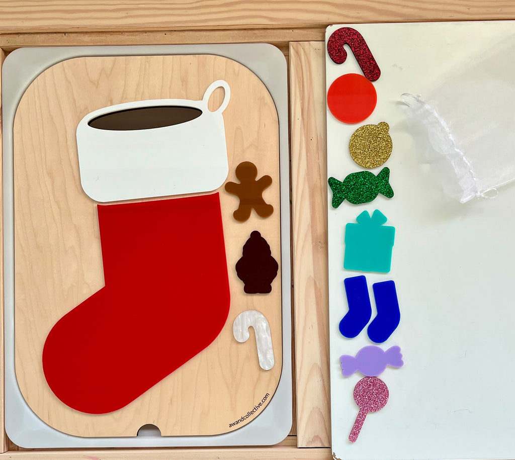 Wooden Christmas stocking puzzle pieces including a red stocking, white cuff, gingerbread man, candy cane, and tree shape on a wooden tray