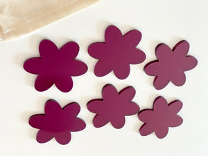 Set of six flower-shaped dry erasable boards in varying shades of purple on white background