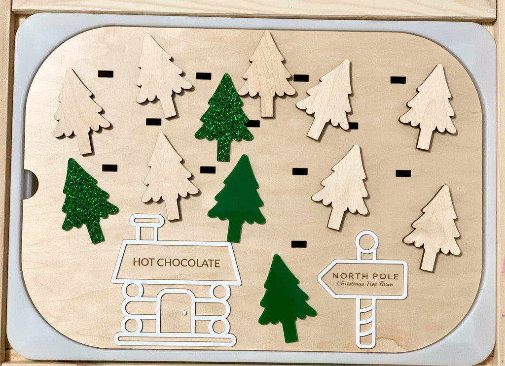 Wooden Flisat insert with 12 plantable Christmas trees in maple plywood and green acrylic, plus Hot Chocolate and North Pole signs