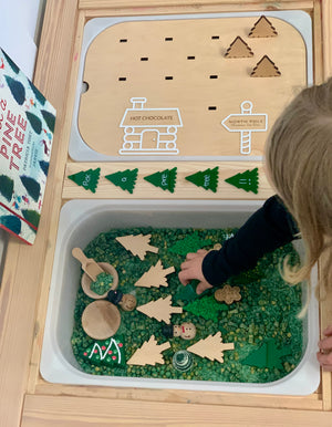 Wooden North Pole Christmas Tree Farm Flisat insert with plantable trees, green sensory base, and child playing with pieces