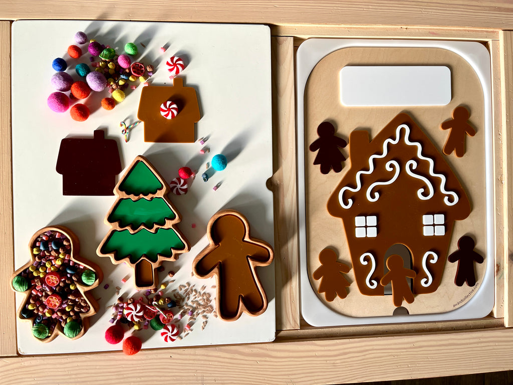 Gingerbread house, tree, and person-shaped trays with colorful pom-poms, beads, and candy decorations on wooden surface