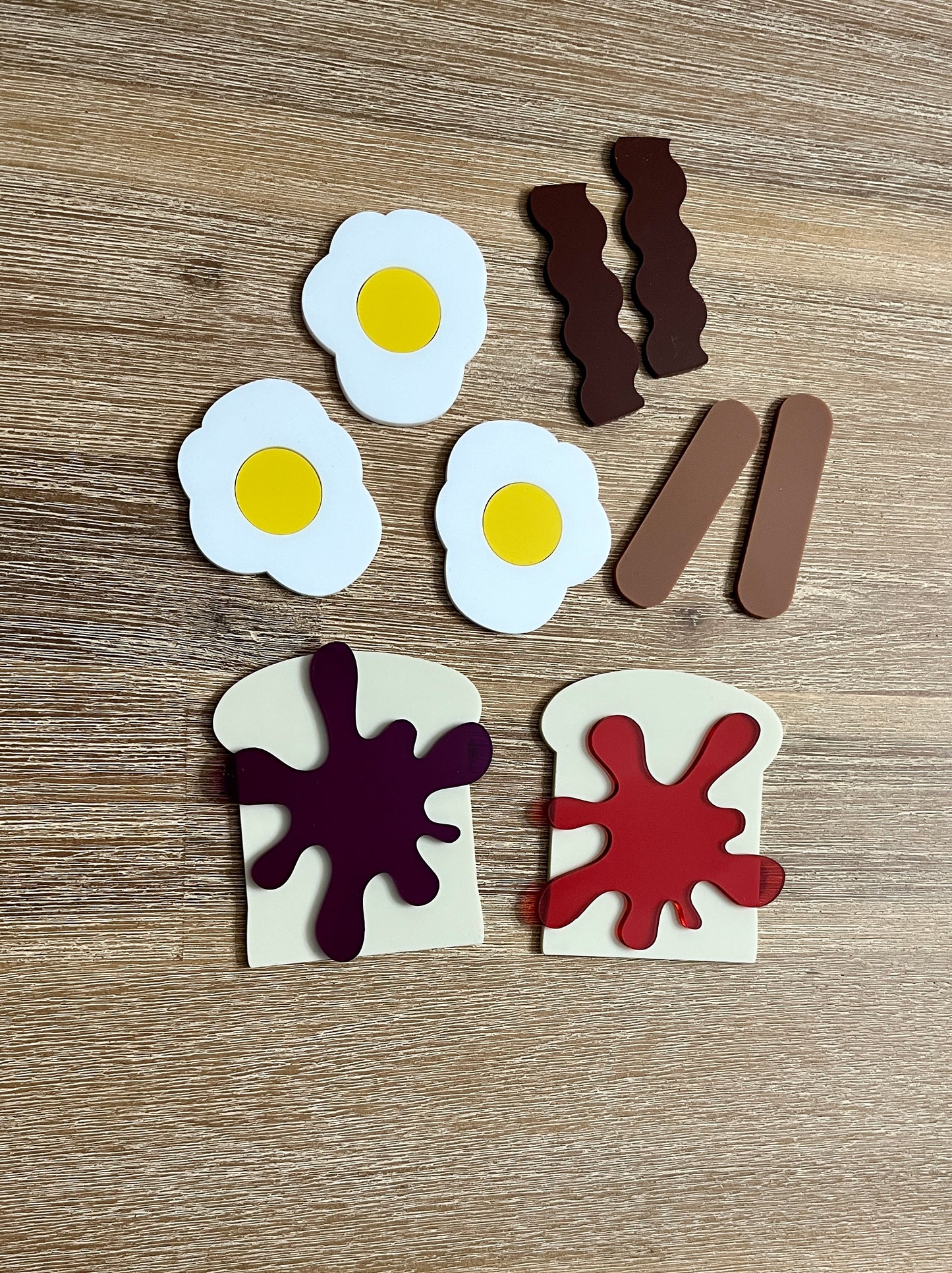 Little Dry Erasables - Breakfast Toast with Jam, Bacon, Sausage and Eggs featuring handcrafted wooden play pieces of fried eggs, bacon strips, sausage links, and toast with vibrant jam spots for homeschool education resources.