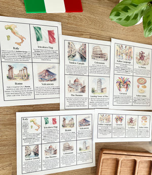 Digital Download | Italy Informational Flash Cards | Comes With 2 Sizes displaying watercolor illustrations and facts about Italy’s landmarks, culture, language, and geography on wooden tabletop with leaf and flag, handcrafted homeschool education resources.