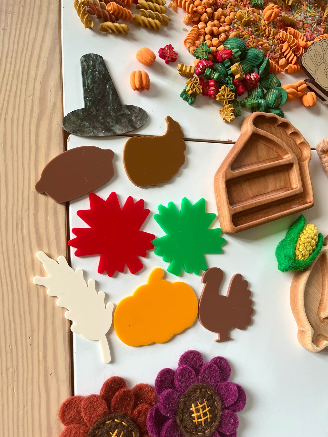 Autumn-themed acrylic shapes including pumpkin, turkey, leaf, acorn, and witch hat with wooden pie tray and felt sunflowers