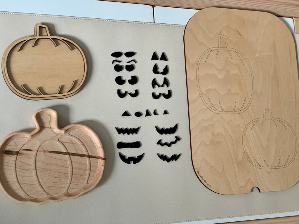 Wooden jack o lantern pumpkin trays with laser cut pumpkin face shapes and pumpkin outline trays on white surface
