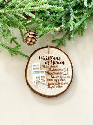 Wood slice Christmas ornament with memorial poem and small white wooden rocking chair hanging on pine branch