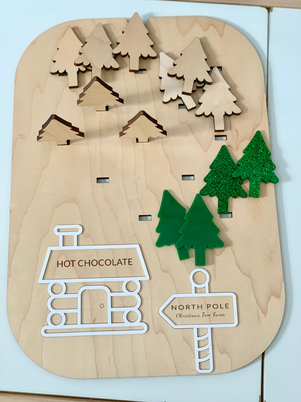 Wooden Christmas tree farm Flisat insert with maple plywood trees, green acrylic trees, and hot chocolate cabin and sign pieces