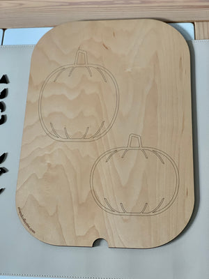 Wooden board with two pumpkin outlines engraved, designed as a Halloween or fall Flisat insert on light surface