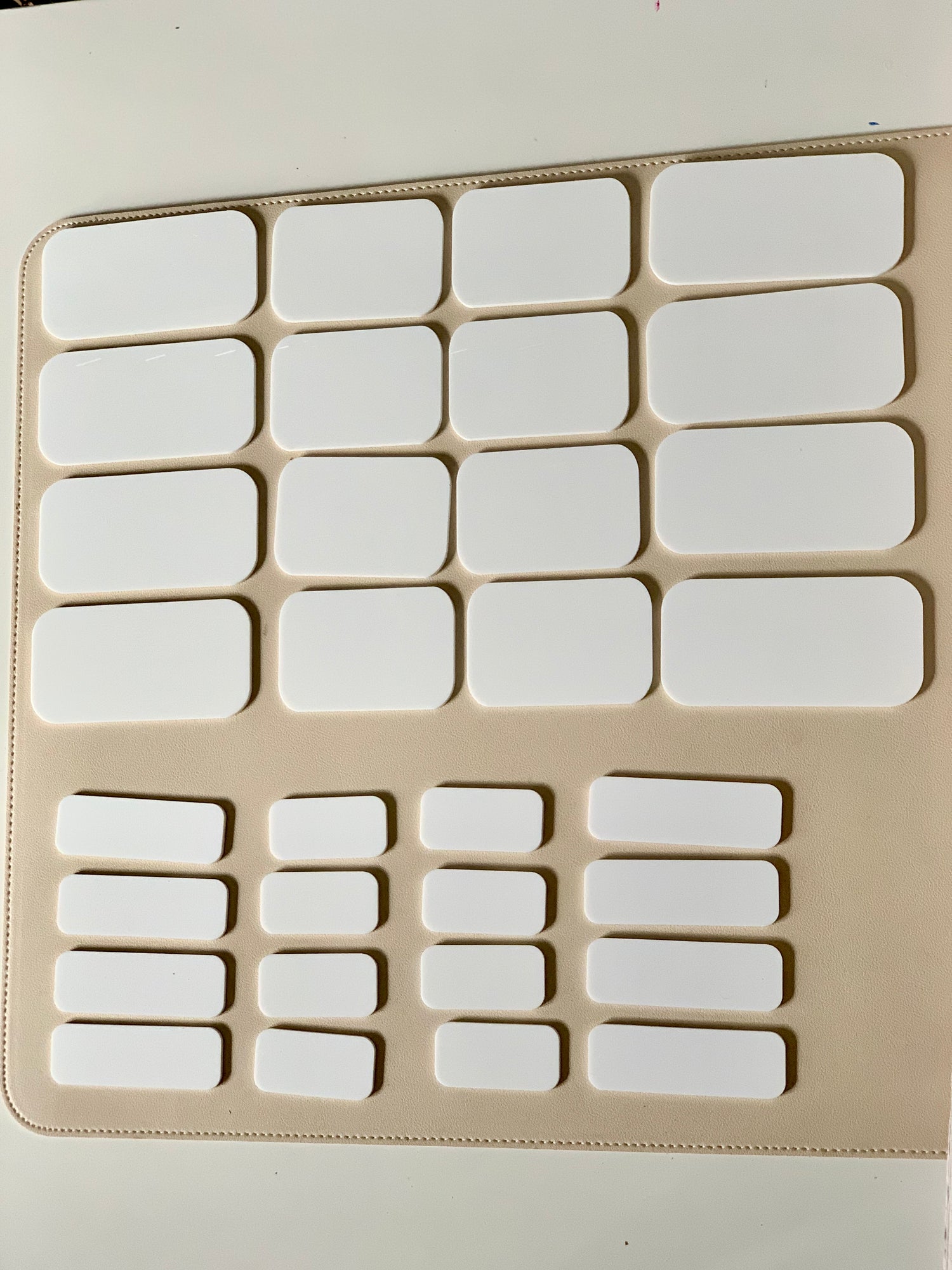 16 white dry erase placards in two sizes arranged on beige background with rounded corners and blank surfaces