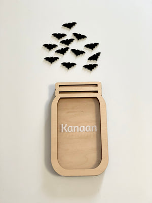 Personalized wooden jar shaped reward container with name and small black bat cutouts on white background