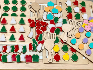 Wooden cookie sheet and colorful wooden cookies with attached hook and loop on light wood table