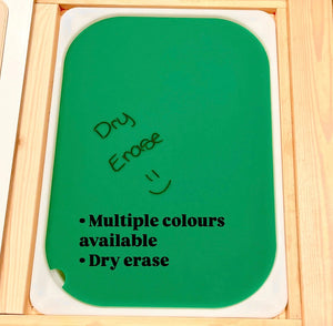 Green dry erase board with rounded corners and handwritten text on a wooden framed surface