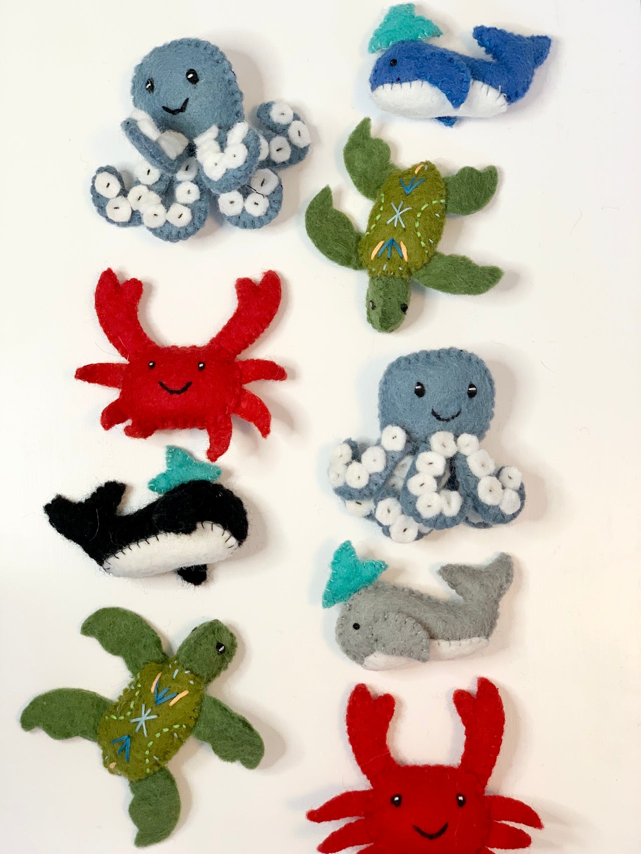 Handmade felt sea creatures including octopus, crab, turtle, whale, and shark on white background