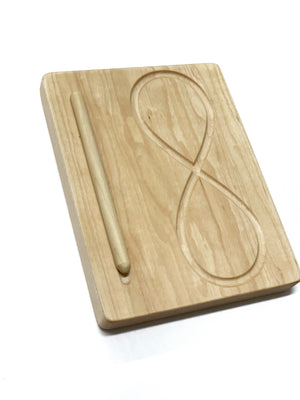 Canadian maple hardwood figure eight tracing board with smooth engraved infinity shape and wooden stylus on white background