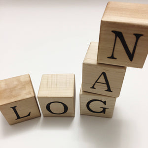 Natural wooden 1.5 inch alphabet blocks with black engraved letters arranged to spell LOGAN on white background