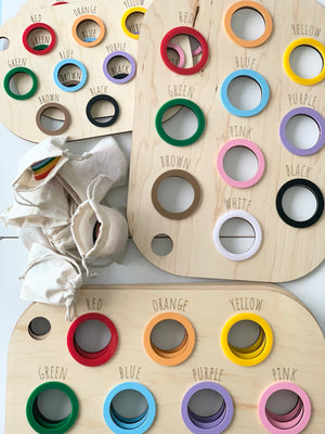 Light natural maple plywood Flisat table bin lids with engraved color names and colored wooden rings for sorting activity