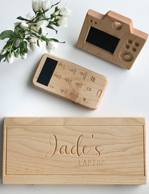 Natural wooden toy laptop and phone with chalkboard screens and engraved name on wooden base on white background