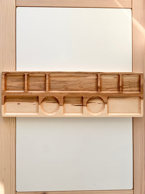 Extra large wooden tinker tray plate with various rectangular and circular compartments on light wood background