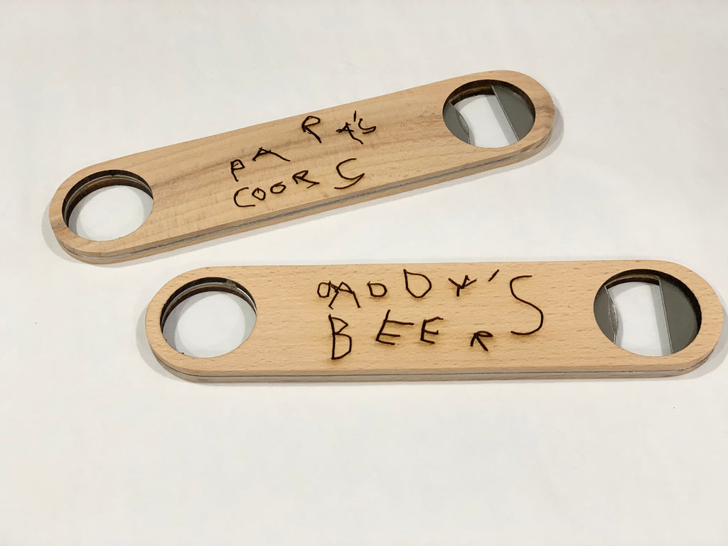 Two natural wooden custom bottle openers with handwritten-style engraved text on plain white background