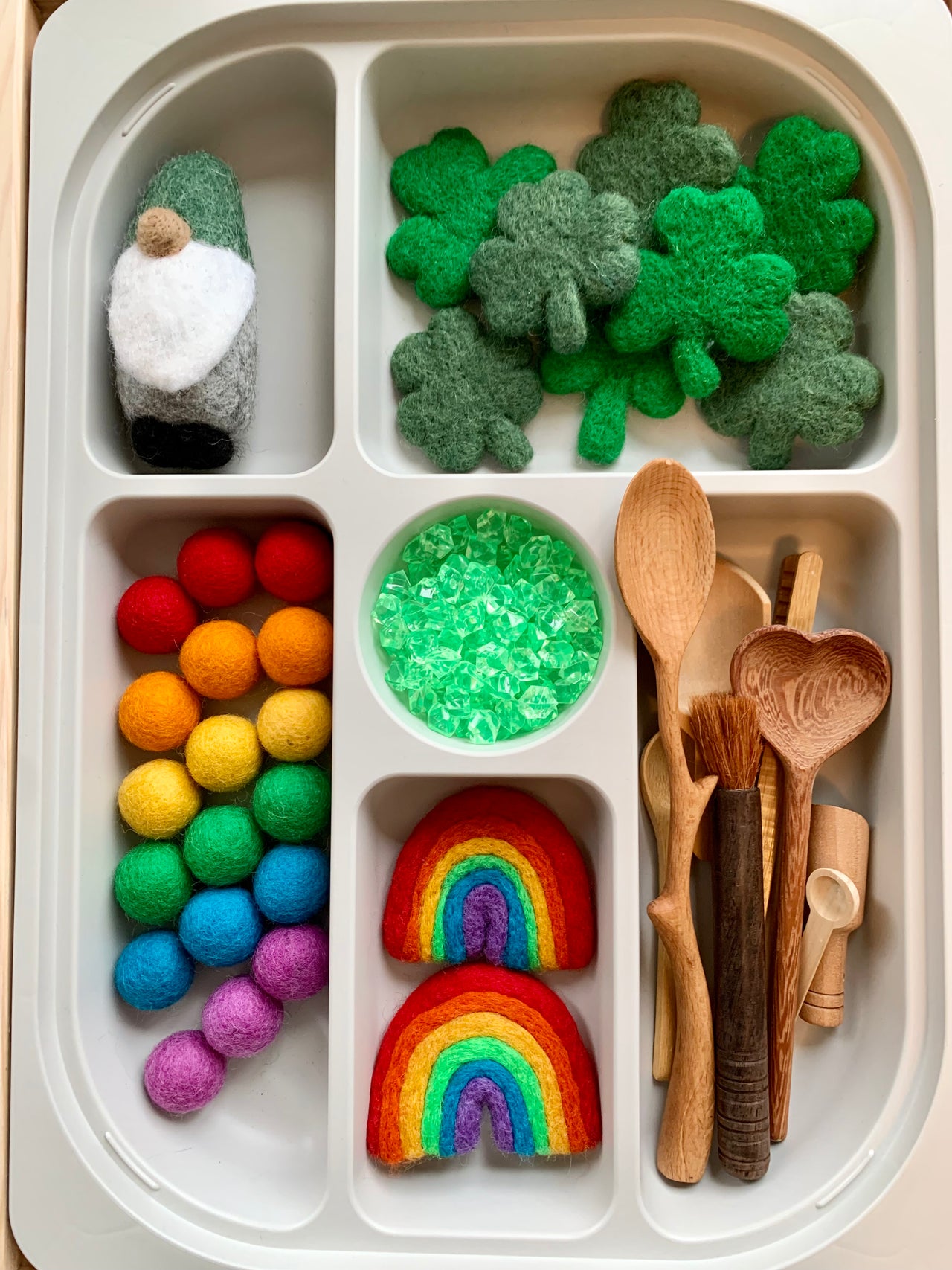 Flisat sorting tray with felt clovers, rainbow felt pieces, wooden spoons, colorful felt balls, and a small felt gnome