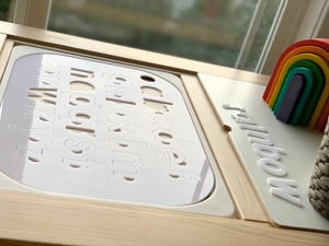 Lowercase alphabet puzzle Flisat table top insert with white acrylic letters and rainbow wooden toy on wooden frame