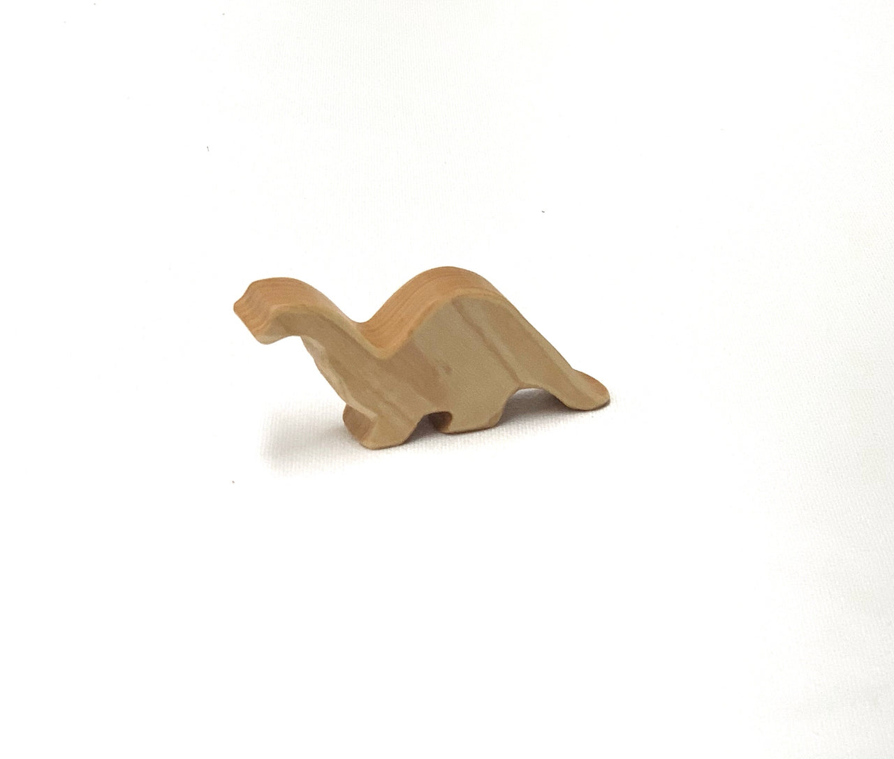 Small natural wooden baby long neck brachiosaurus toy figurine on plain white background
